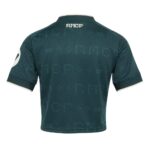 Camiseta cropped para mujer del Real Madrid, tercera equipación 26/27 en color verde. Vista frontal de la prenda.